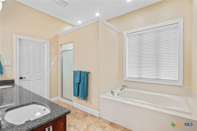 full bathroom with a sink, double vanity, a stall shower, visible vents, and a garden tub