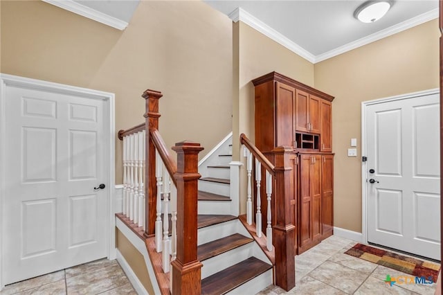 foyer entrance with stairs, crown molding, baseboards, and light tile patterned floors