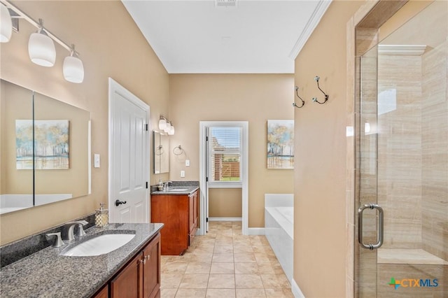 bathroom with a garden tub, two vanities, a sink, and a stall shower