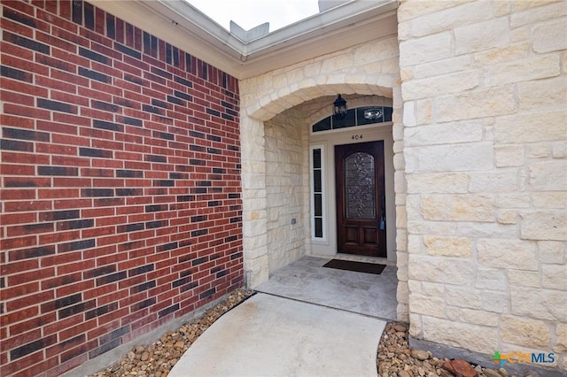view of exterior entry featuring stone siding
