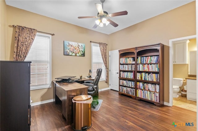 office space featuring ceiling fan, baseboards, and wood finished floors
