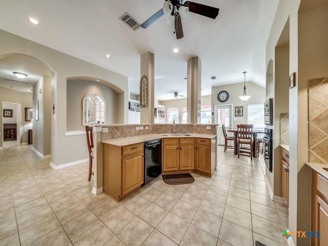 kitchen with light countertops, a sink, a ceiling fan, visible vents, and black appliances