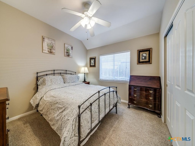 bedroom featuring baseboards, vaulted ceiling, a closet, and carpet