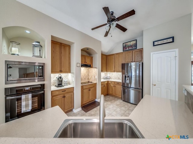kitchen with black appliances, light countertops, and a sink