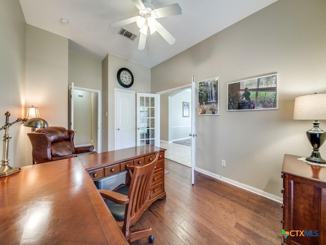 office with baseboards, visible vents, a ceiling fan, and dark wood finished floors
