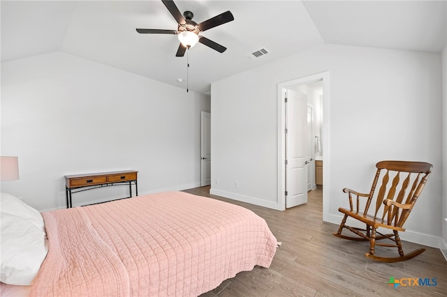 532 Elm Green St, Hutto, TX 78634 - bedroom featuring vaulted ceiling, wood finished floors, and connected bathroom