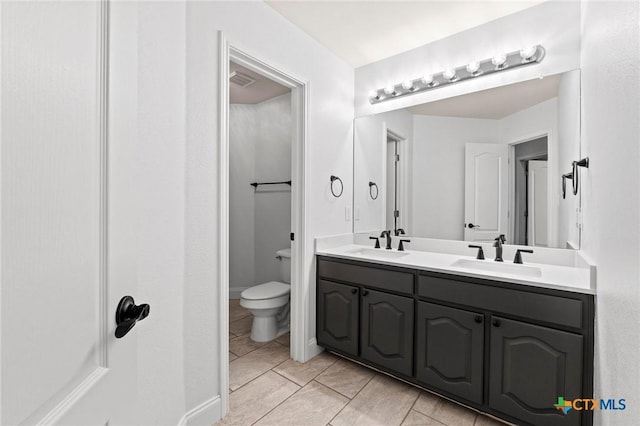 1428 Windcrest Dr, Round Rock, TX 78664 - full bath with double vanity, tile patterned floors, and toilet