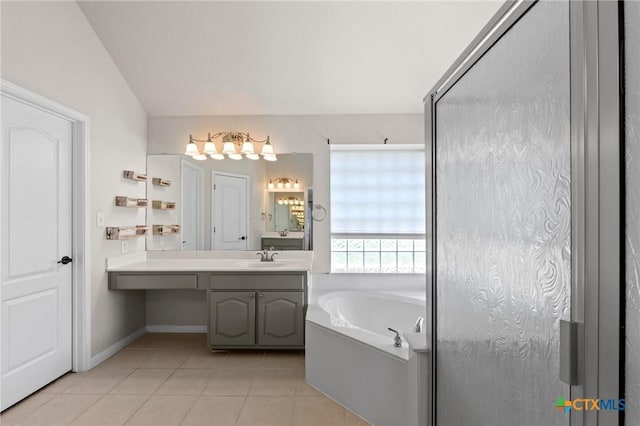 1428 Windcrest Dr, Round Rock, TX 78664 - bathroom with tile patterned flooring, a bath, vanity, baseboards, and a chandelier