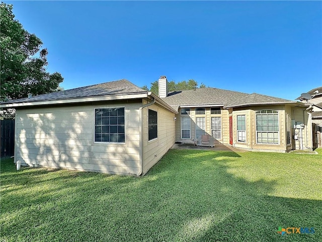 203 Canyon Crk, Victoria, TX 77901 - rear view of house featuring a chimney