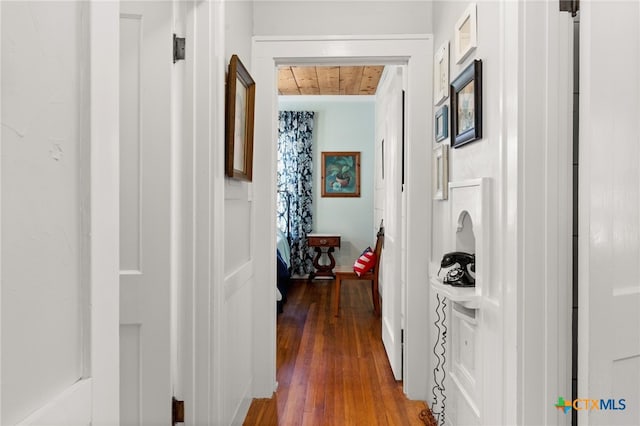 hall with wood ceiling, a healthy amount of sunlight, and dark hardwood / wood-style floors