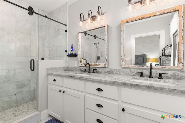 bathroom featuring vanity and a shower with shower door