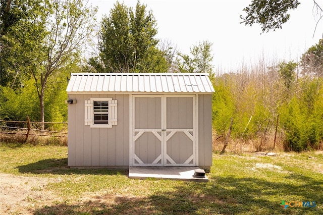 view of outbuilding with a lawn