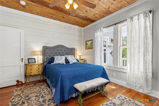 bedroom featuring wood ceiling, wood-type flooring, ceiling fan, and crown molding