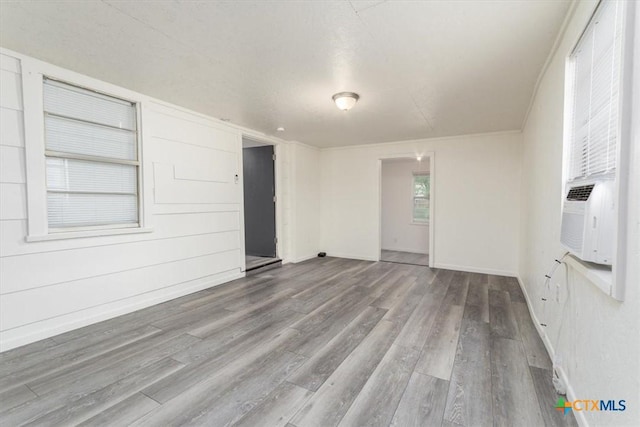 303 Sumbera St, Holland, TX 76534 - unfurnished room with baseboards, cooling unit, and wood finished floors