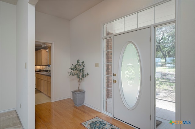 entryway with sink and light wood-type flooring