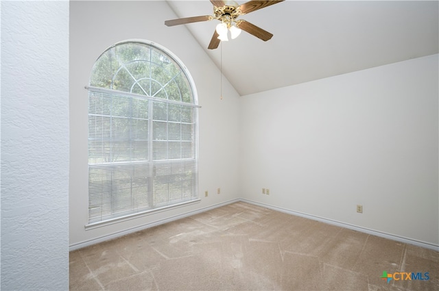 carpeted spare room featuring ceiling fan and high vaulted ceiling