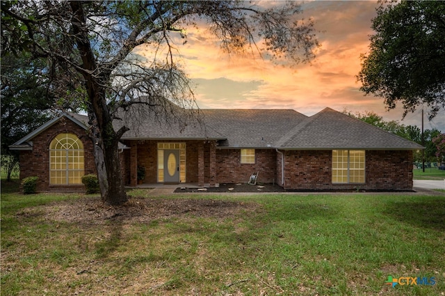 ranch-style house with a yard