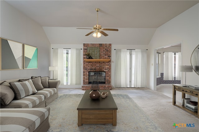 living room featuring high vaulted ceiling, light carpet, ceiling fan, and a brick fireplace