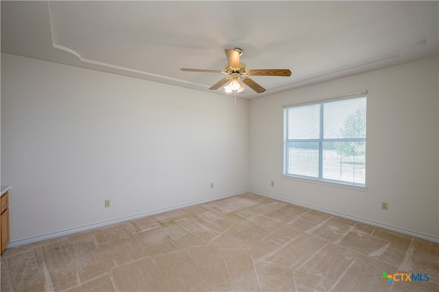 carpeted spare room with ceiling fan