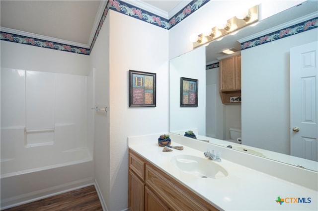 full bathroom with crown molding, vanity, shower / bathing tub combination, hardwood / wood-style flooring, and toilet