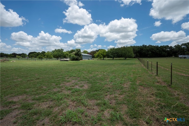 view of yard with a rural view