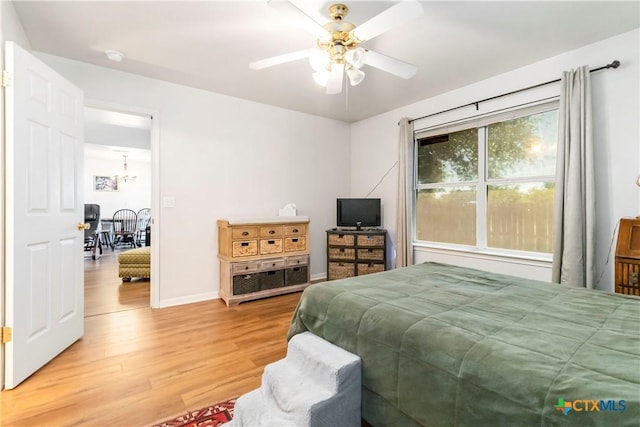 2039 Cornerstone Dr, New Braunfels, TX 78130 - bedroom with light wood-style floors, a chandelier, and ceiling fan