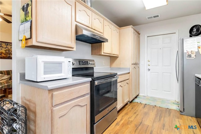2039 Cornerstone Dr, New Braunfels, TX 78130 - kitchen with stainless steel appliances, under cabinet range hood, light brown cabinets, light wood-style flooring, and light countertops