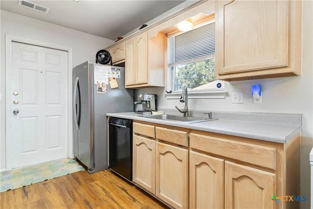2039 Cornerstone Dr, New Braunfels, TX 78130 - kitchen with dishwasher, light brown cabinetry, light wood finished floors, light countertops, and freestanding refrigerator