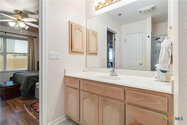 2039 Cornerstone Dr, New Braunfels, TX 78130 - bathroom with connected bathroom, vanity, ceiling fan, wood finished floors, and a shower