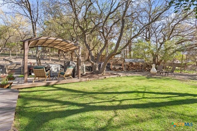 view of yard featuring a pergola and a deck