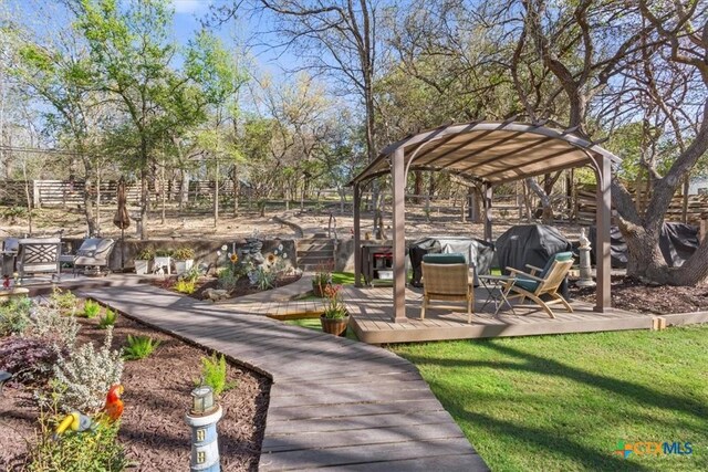 surrounding community with a yard, a deck, and fence