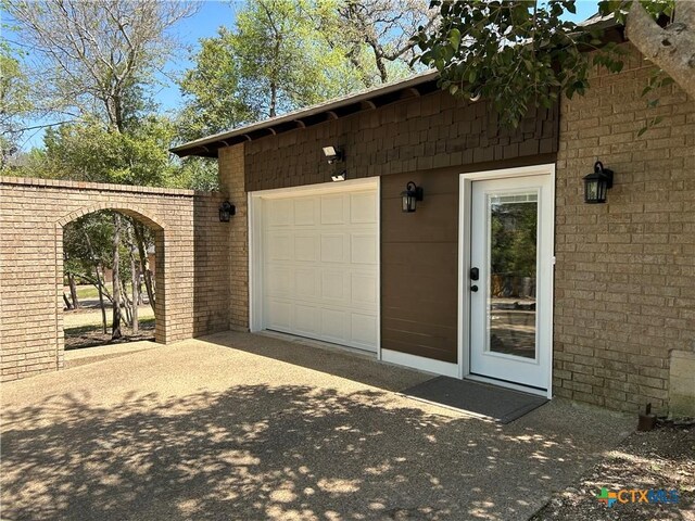 garage featuring concrete driveway