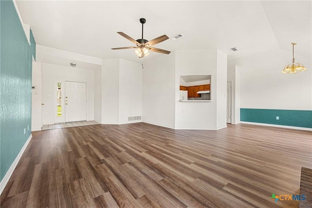 809 Filly Ln, Temple, TX 76504 - unfurnished living room with wood finished floors, ceiling fan, baseboards, and a chandelier