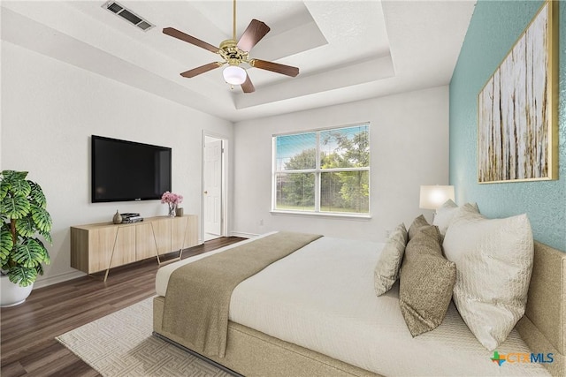 809 Filly Ln, Temple, TX 76504 - bedroom featuring wood finished floors, a tray ceiling, ceiling fan, and baseboards