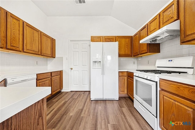 809 Filly Ln, Temple, TX 76504 - kitchen with white appliances, under cabinet range hood, brown cabinets, dark wood-type flooring, and light countertops