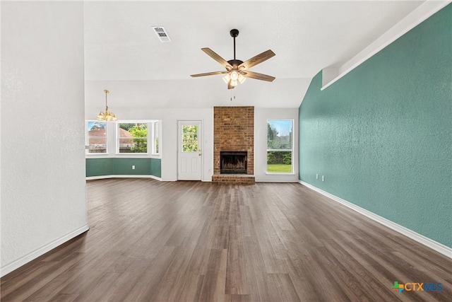 809 Filly Ln, Temple, TX 76504 - unfurnished living room with a textured wall, lofted ceiling, dark wood-style flooring, plenty of natural light, and baseboards