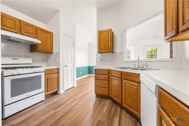 809 Filly Ln, Temple, TX 76504 - kitchen featuring white appliances, under cabinet range hood, a sink, and tasteful backsplash