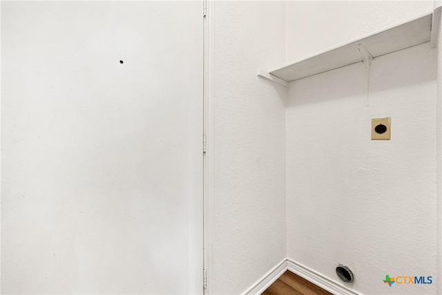 809 Filly Ln, Temple, TX 76504 - laundry room with dark wood finished floors, baseboards, and electric dryer hookup