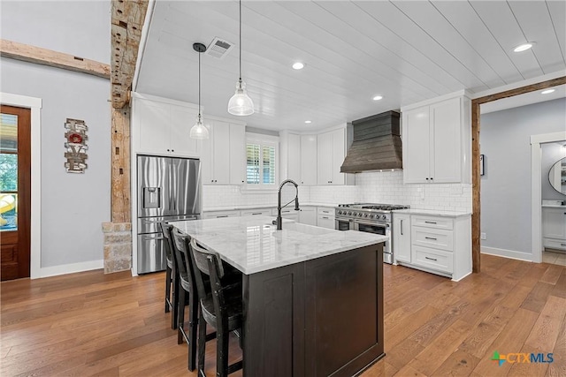 8300 Spicewood Springs Rd, China Spring, TX 76633 - kitchen featuring appliances with stainless steel finishes, wall chimney range hood, a sink, baseboards, and recessed lighting