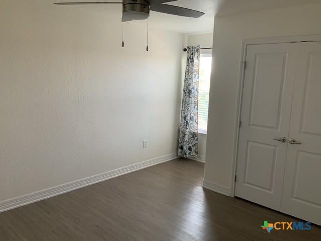 5818 Hamlet Dr, Belton, TX 76513 - empty room featuring dark wood-style floors, a ceiling fan, and baseboards