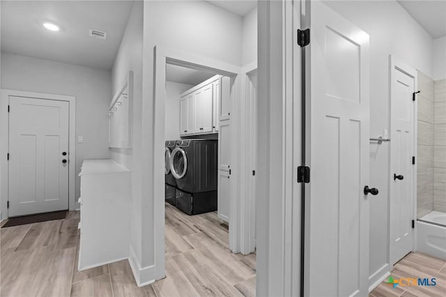 4430 Cedar Creek Rd, Temple, TX 76504 - laundry area with separate washer and dryer, cabinet space, and light wood-type flooring
