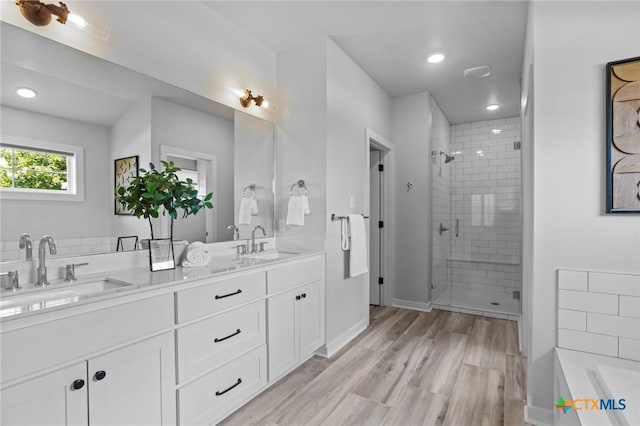 4430 Cedar Creek Rd, Temple, TX 76504 - full bath featuring a stall shower, double vanity, a bath, wood finished floors, and recessed lighting