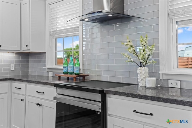 4430 Cedar Creek Rd, Temple, TX 76504 - kitchen featuring stainless steel electric range, wall chimney exhaust hood, tasteful backsplash, and white cabinetry