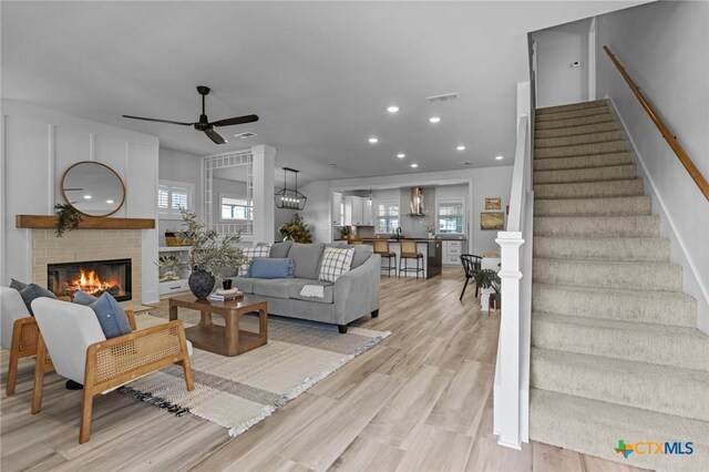 4430 Cedar Creek Rd, Temple, TX 76504 - living room featuring a ceiling fan, stairs, a fireplace, light wood finished floors, and recessed lighting