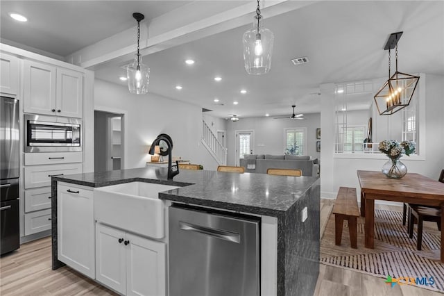 4430 Cedar Creek Rd, Temple, TX 76504 - kitchen with appliances with stainless steel finishes, recessed lighting, light wood-style floors, a kitchen island with sink, and dark stone counters