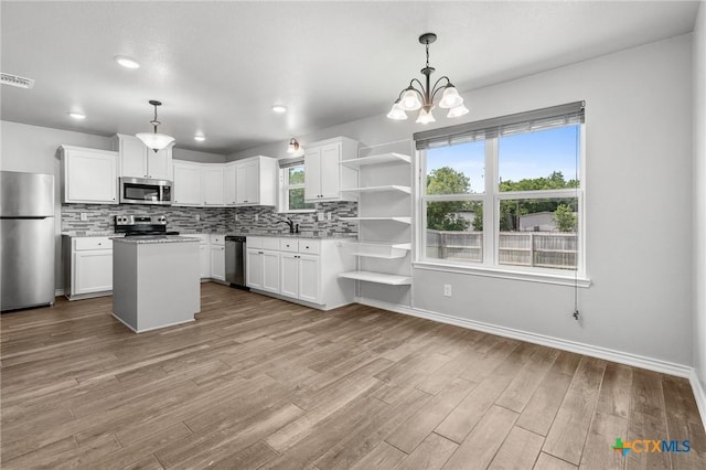 2550 Belle Hubbard Trl, Belton, TX 76513 - kitchen with appliances with stainless steel finishes, open shelves, tasteful backsplash, wood finished floors, and recessed lighting