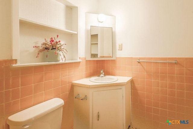 1905 S 53rd St, Temple, TX 76504 - half bath with wainscoting, vanity, tile walls, and toilet