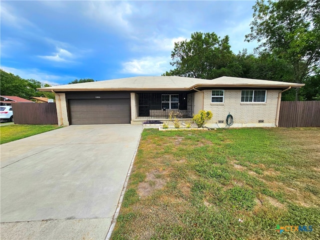 ranch-style house with a garage and a front lawn