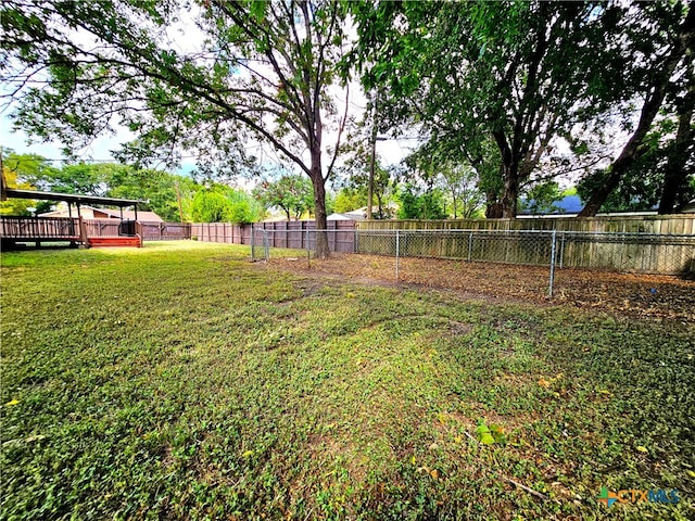 view of yard with a wooden deck