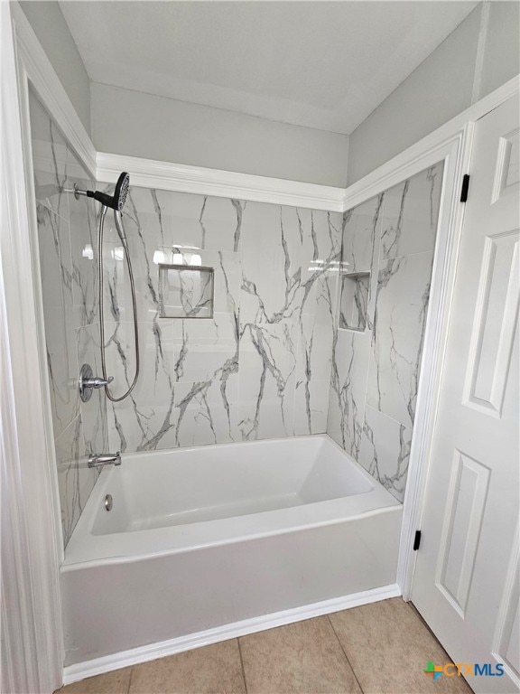 bathroom with tiled shower / bath combo and tile patterned floors